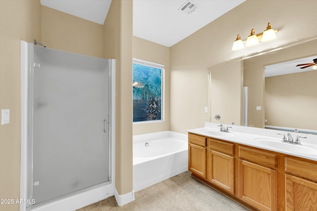 bathroom featuring ceiling fan, vanity, and shower with separate bathtub