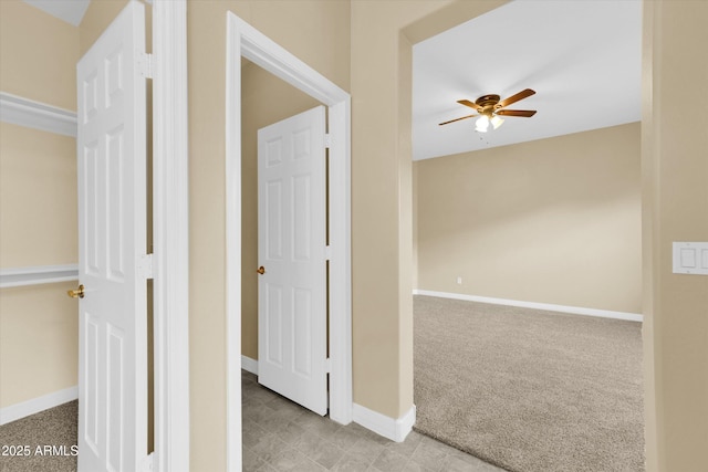 hallway featuring light colored carpet