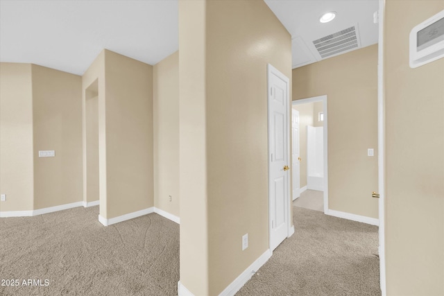 hall with light colored carpet