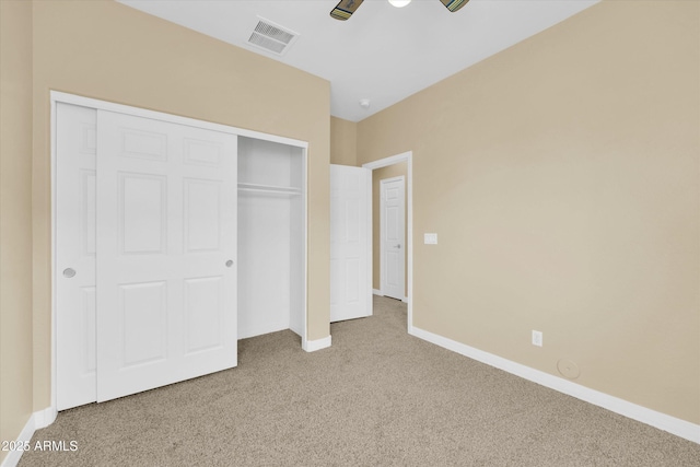 unfurnished bedroom featuring ceiling fan, carpet floors, and a closet