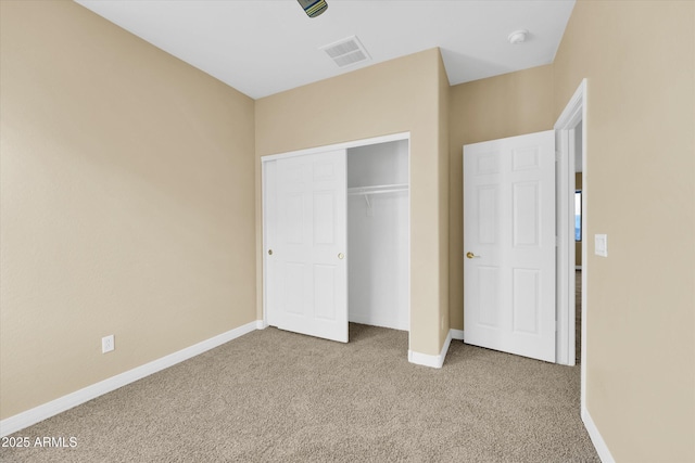 unfurnished bedroom featuring a closet and carpet flooring