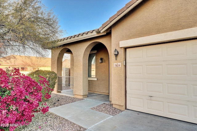 doorway to property with a garage