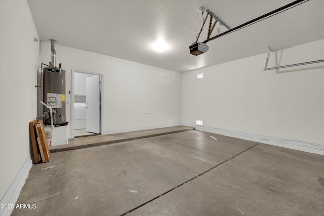 garage featuring washer / clothes dryer, a garage door opener, and water heater