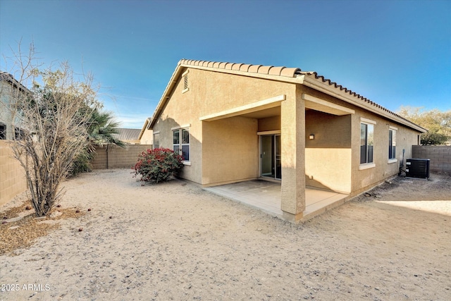 back of house with central AC unit and a patio area