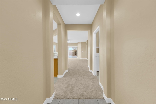 corridor featuring light colored carpet