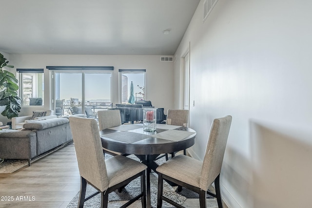 dining area featuring light wood-type flooring