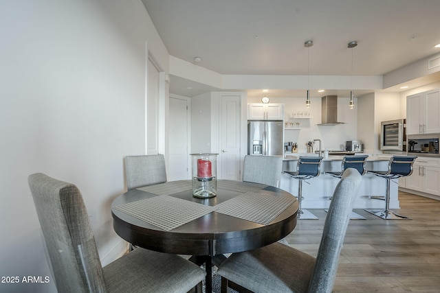 dining space with light wood-type flooring