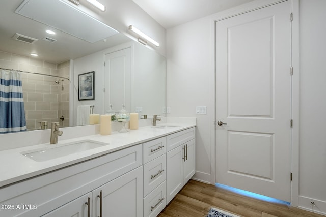 bathroom with a shower with curtain, vanity, and wood-type flooring