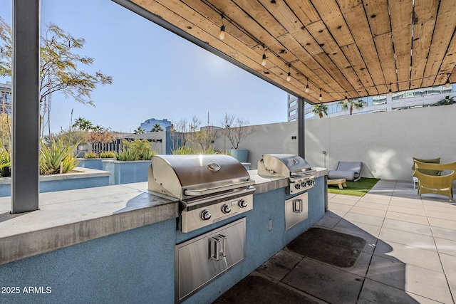 view of patio with area for grilling and exterior kitchen