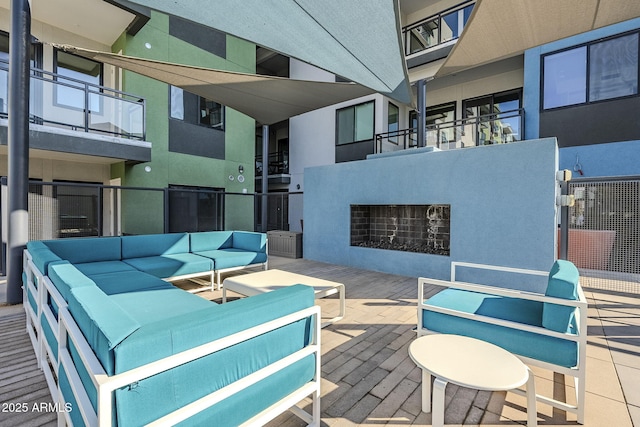 view of patio / terrace with an outdoor living space with a fireplace