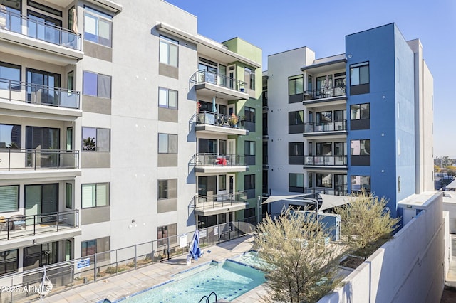 view of building exterior with a community pool