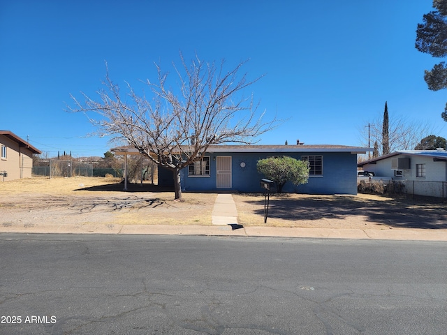 ranch-style home with fence