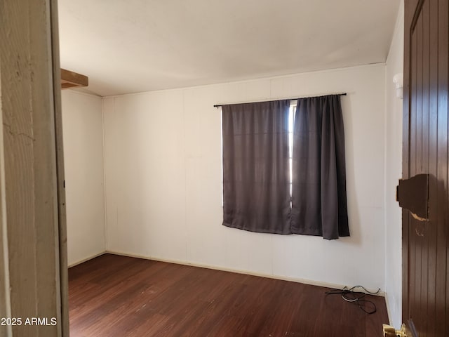 unfurnished room featuring dark wood-style floors