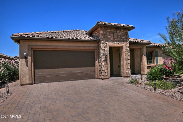 mediterranean / spanish-style home featuring a garage