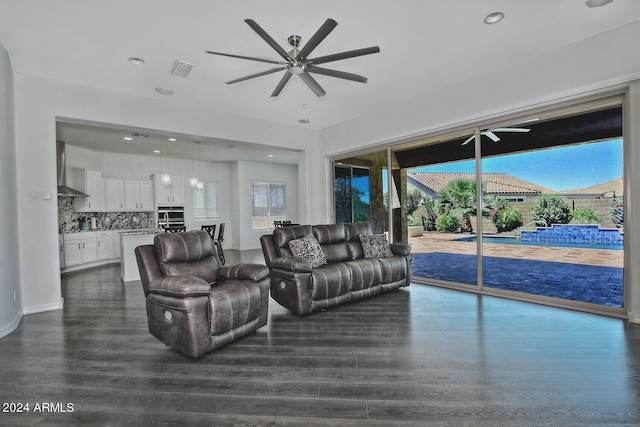 living room featuring ceiling fan and hardwood / wood-style floors