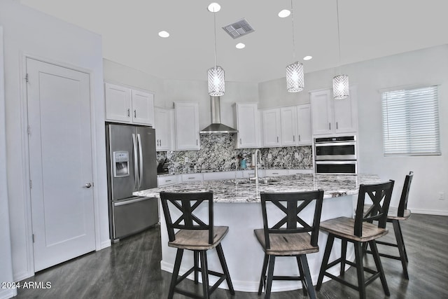 kitchen with appliances with stainless steel finishes, wall chimney range hood, dark hardwood / wood-style floors, and sink