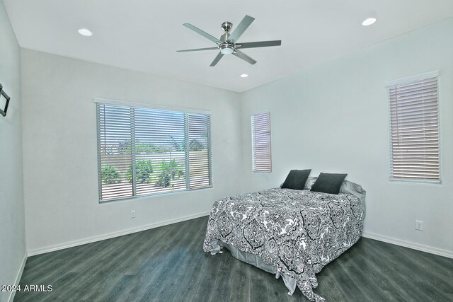 bedroom with dark hardwood / wood-style flooring and ceiling fan