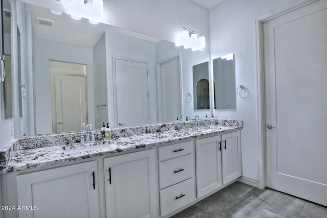 bathroom with tile patterned flooring and double sink vanity