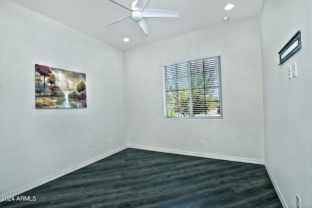 unfurnished room featuring ceiling fan and dark wood-type flooring