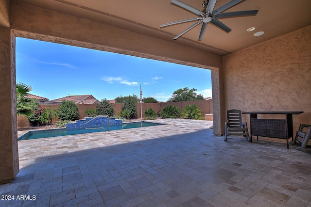 view of patio with ceiling fan and a fenced in pool