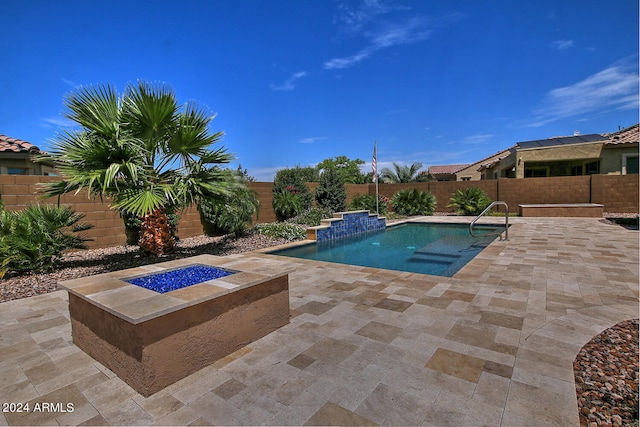 view of pool with pool water feature and a patio area