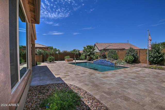 view of swimming pool with a patio area and pool water feature