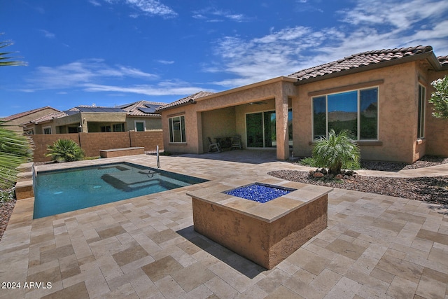 view of swimming pool with a patio area and an outdoor fire pit