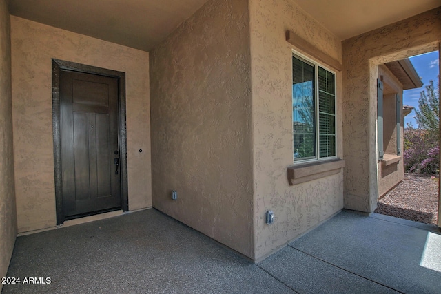 entrance to property with a patio