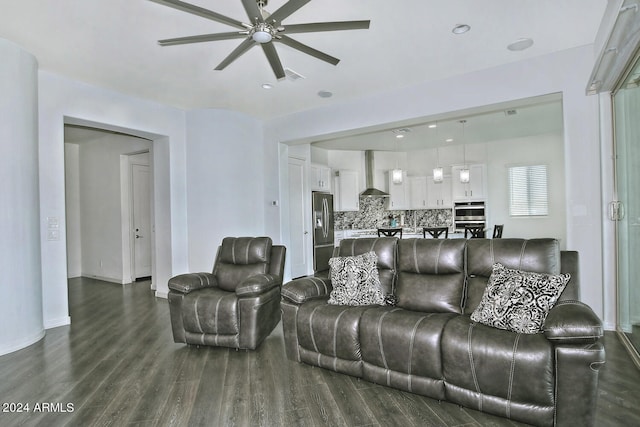 living room with dark hardwood / wood-style flooring and ceiling fan