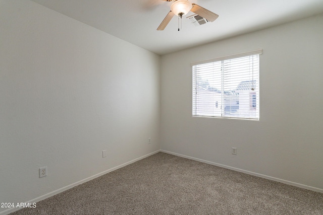 empty room with ceiling fan and carpet