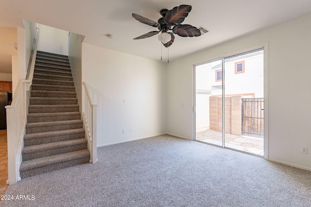 unfurnished living room featuring ceiling fan and carpet floors