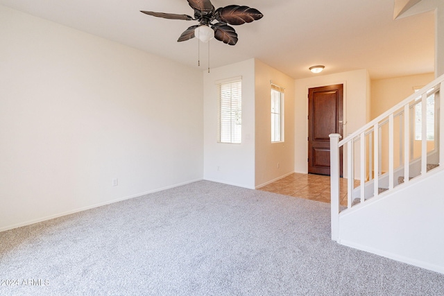 carpeted empty room featuring ceiling fan