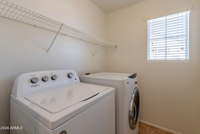 laundry area with light tile patterned flooring and independent washer and dryer