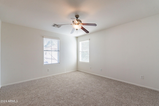 carpeted empty room featuring ceiling fan