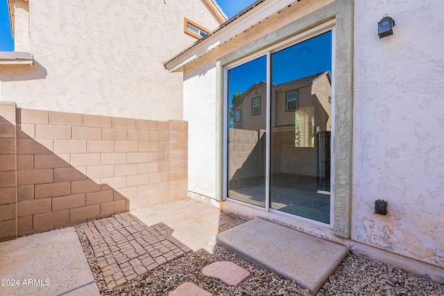 property entrance featuring a patio area