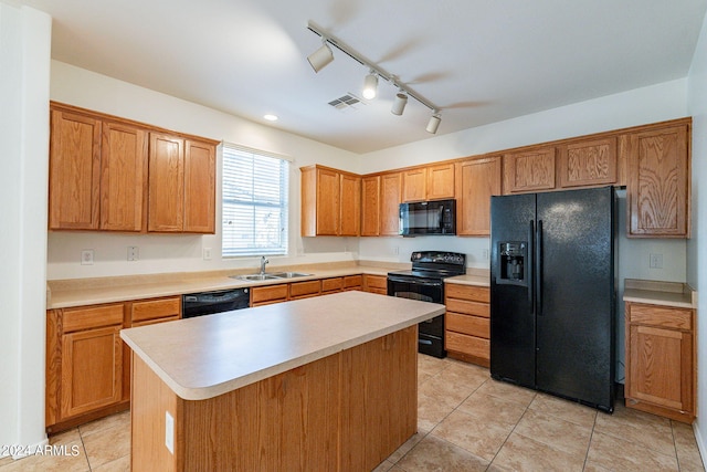 kitchen featuring sink, a center island, track lighting, light tile patterned flooring, and black appliances