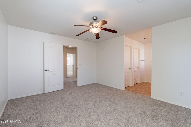 empty room featuring light carpet and ceiling fan