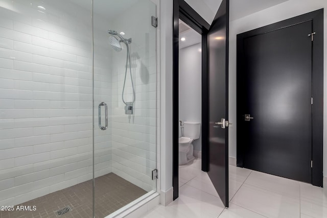 bathroom with tile patterned flooring, toilet, and walk in shower