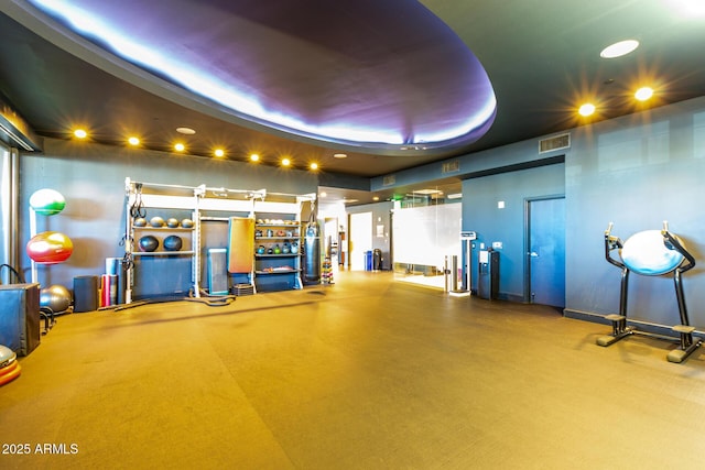 gym with a raised ceiling