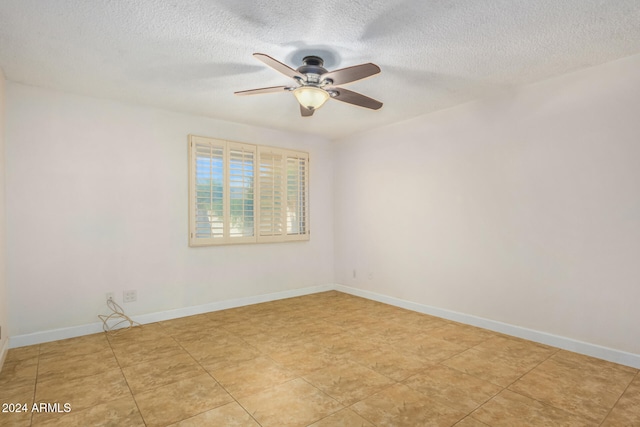 spare room with ceiling fan and a textured ceiling