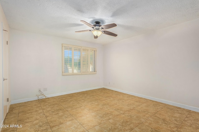 unfurnished room featuring ceiling fan and a textured ceiling