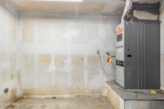 utility room featuring heating unit