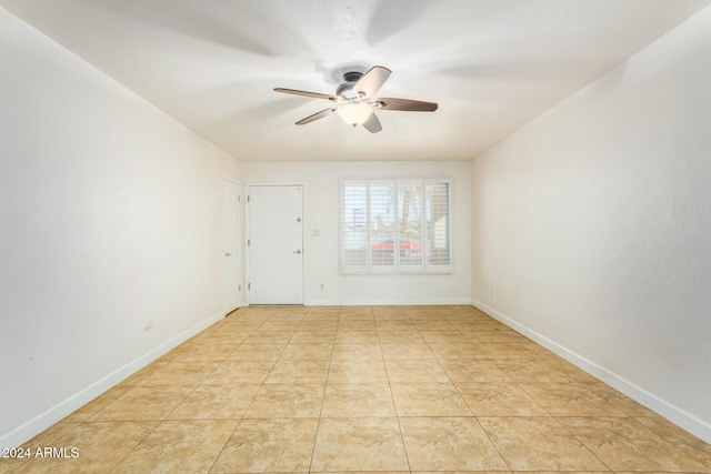 tiled empty room with ceiling fan