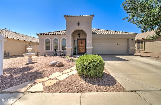 709 E Dry Creek Rd, San Tan Valley, AZ 85143 - mediterranean / spanish home featuring an attached garage, stucco siding, a tile roof, and driveway