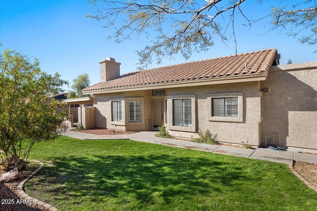 rear view of house with a yard