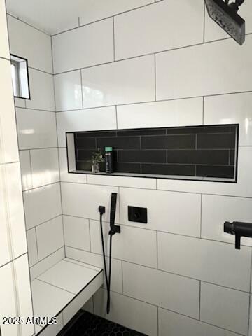 bathroom with a tile shower
