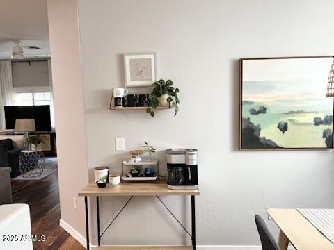 office area with baseboards and wood finished floors