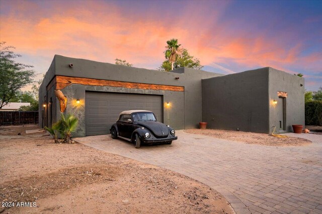 pueblo-style house with a garage