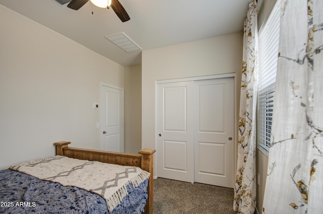 carpeted bedroom with visible vents, a ceiling fan, and a closet