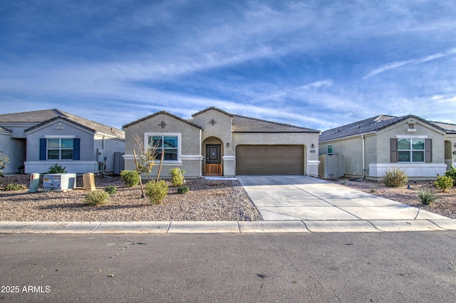 view of front of home featuring an attached garage, concrete driveway, and stucco siding